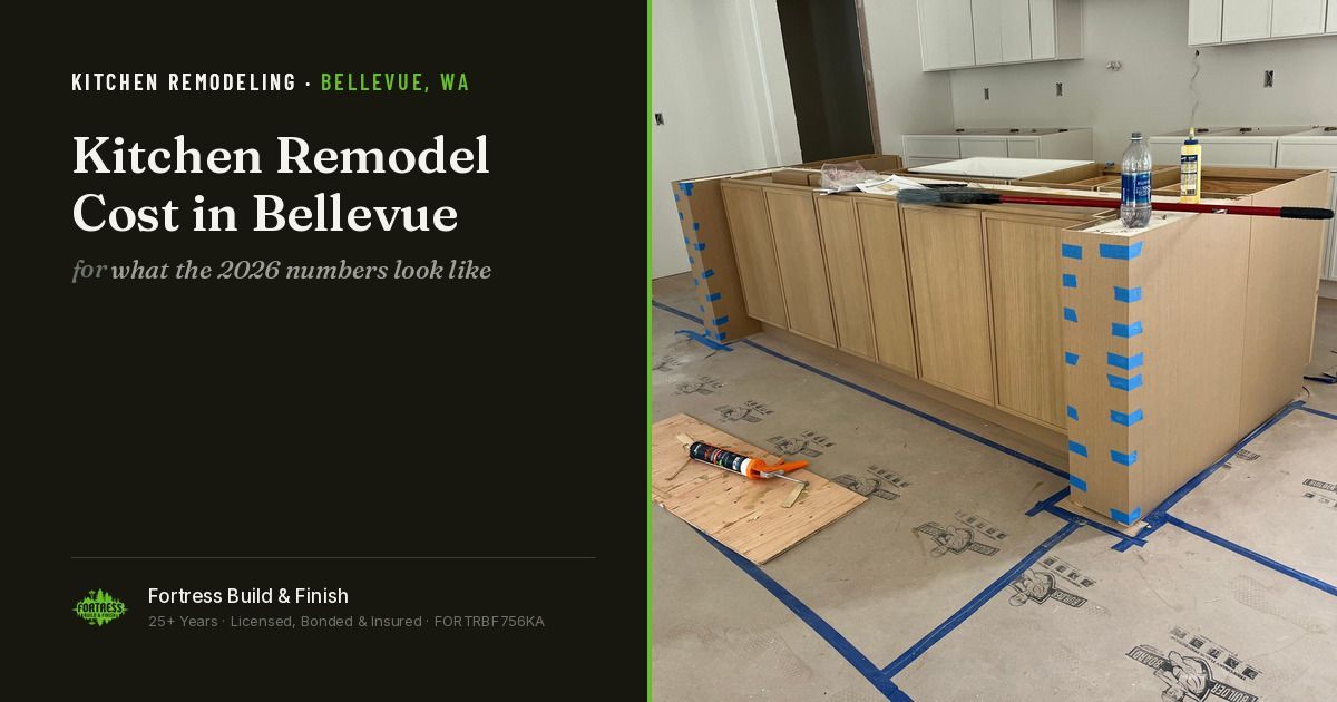 White oak kitchen island under construction in a Bellevue home, perimeter cabinets set and floor protection down, on a Fortress Build & Finish article card titled “Kitchen Remodel Cost in Bellevue.