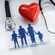 Stethoscope, red heart, and family silhouettes on a medical form, symbolizing health insurance and care