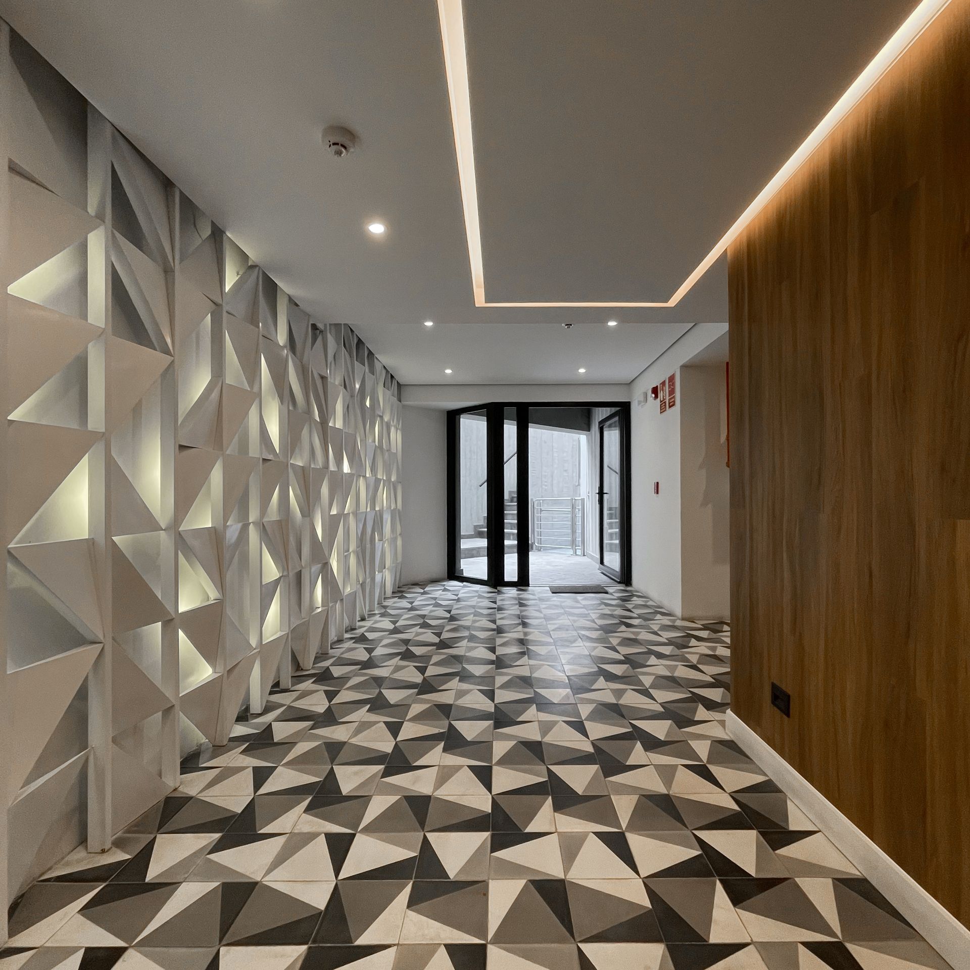 Un pasillo con un patrón geométrico en el suelo.