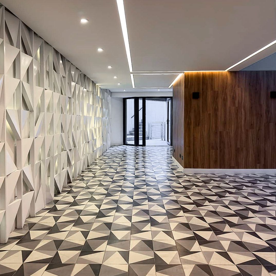 Un pasillo con un patrón geométrico en el suelo y las paredes.