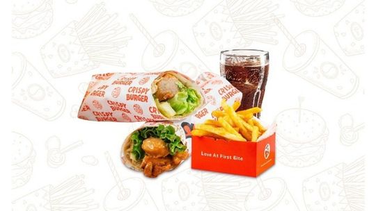 Burger, fries, nuggets, and a drink on a white background, with a burger box and orange fries container.