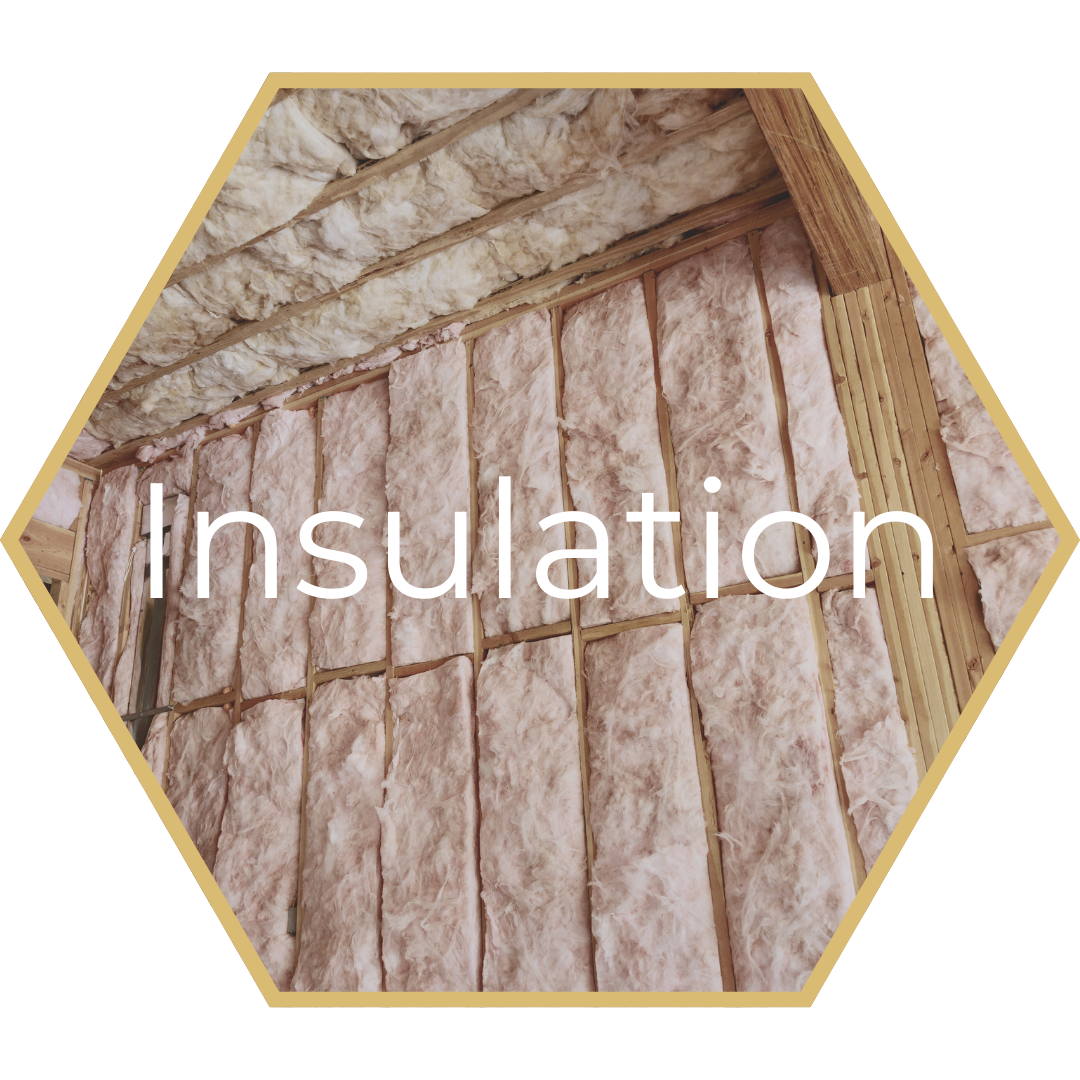 Pink insulation between wooden studs.