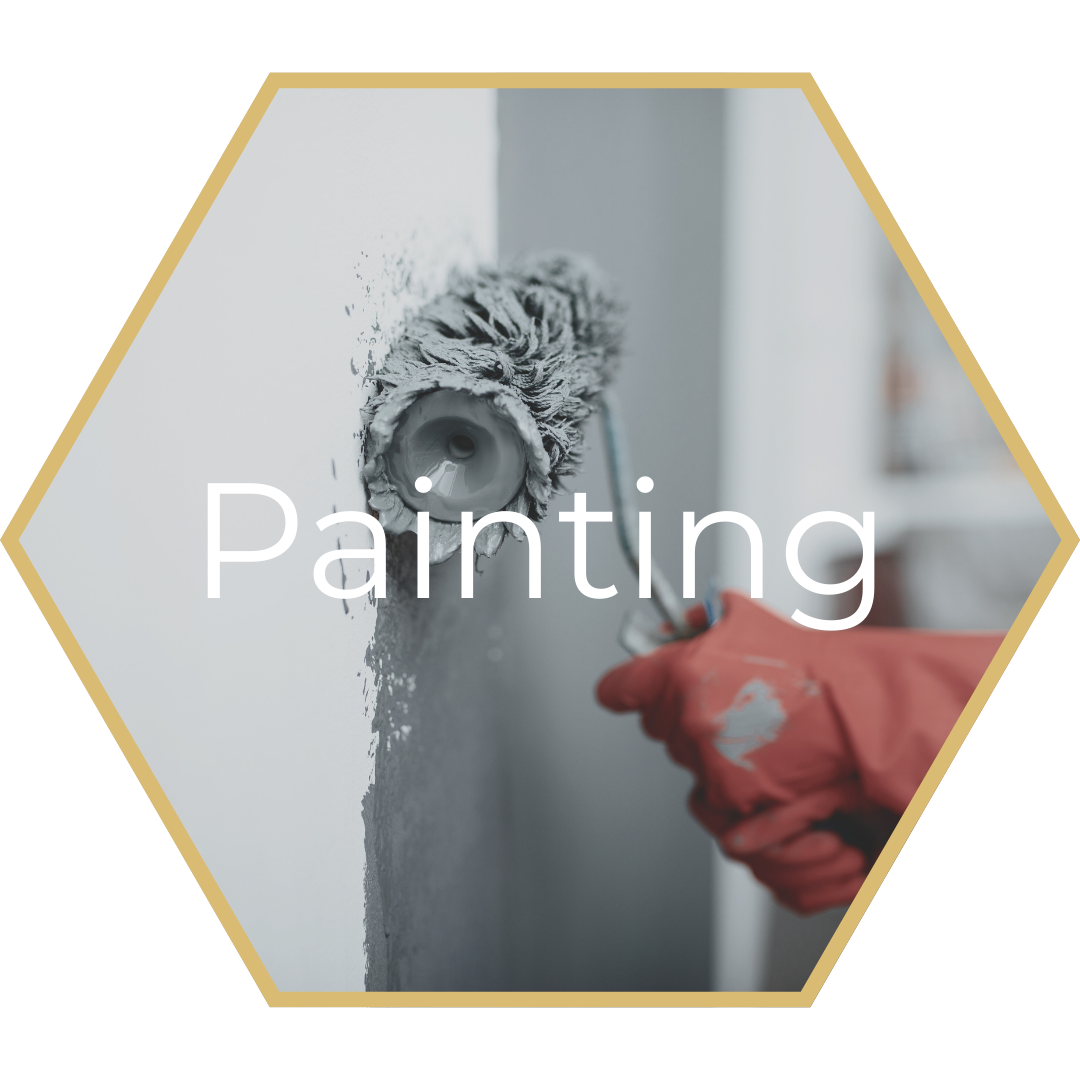Person in red glove painting a wall with a roller.