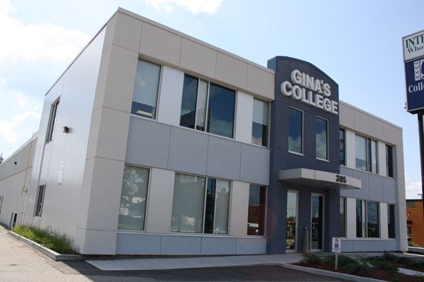 Modern two-story gray building with a “Gina’s College” sign by the entrance