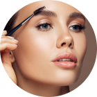 Close-up of a woman applying eyebrow makeup with a brush