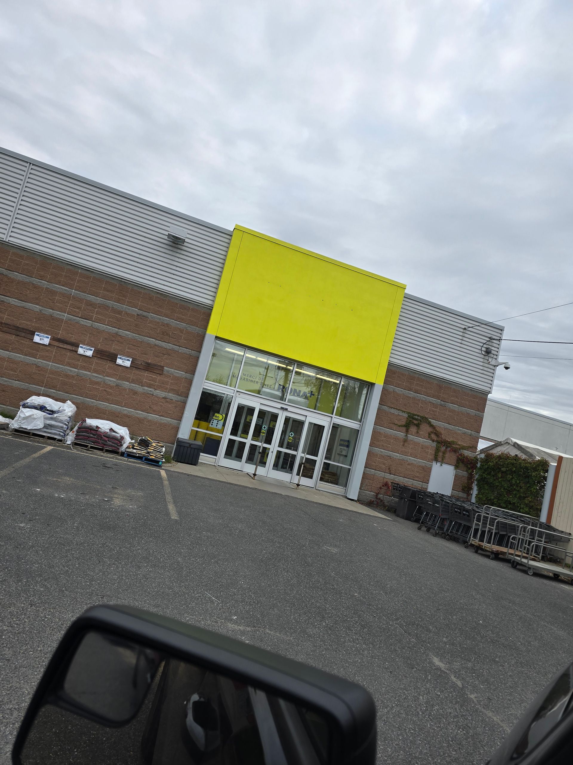 A yellow sign is on the side of a building