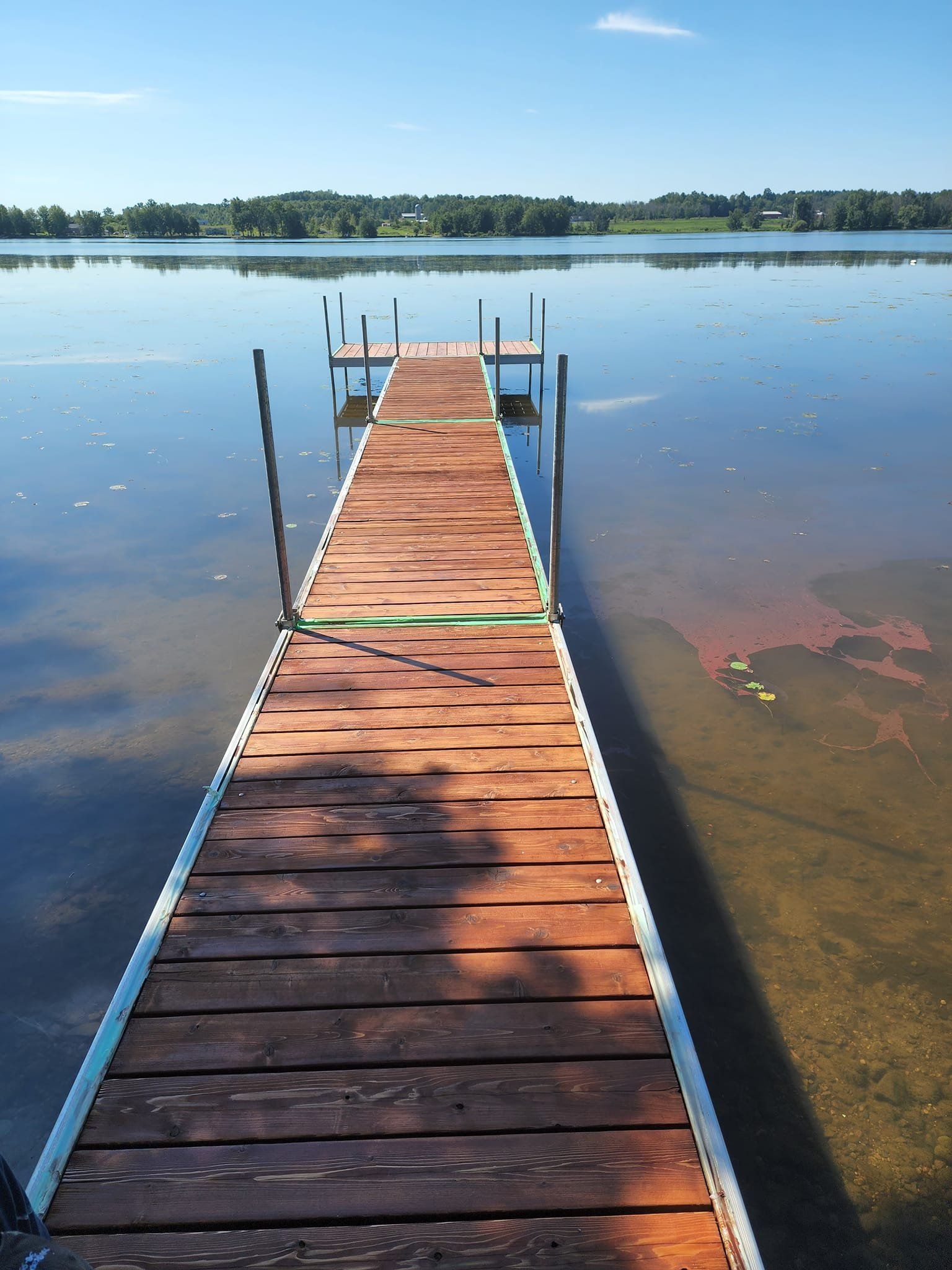 A wooden dock leading into a large body of water