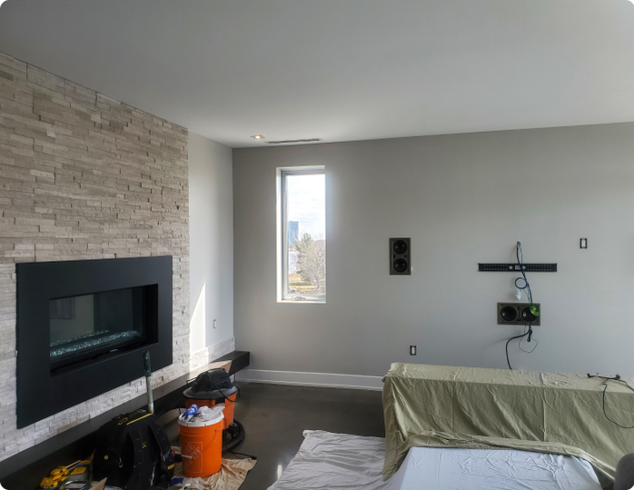 A living room with a fireplace and a window