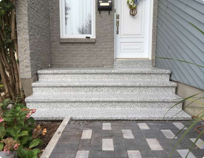 A set of stairs leading up to the front door of a house