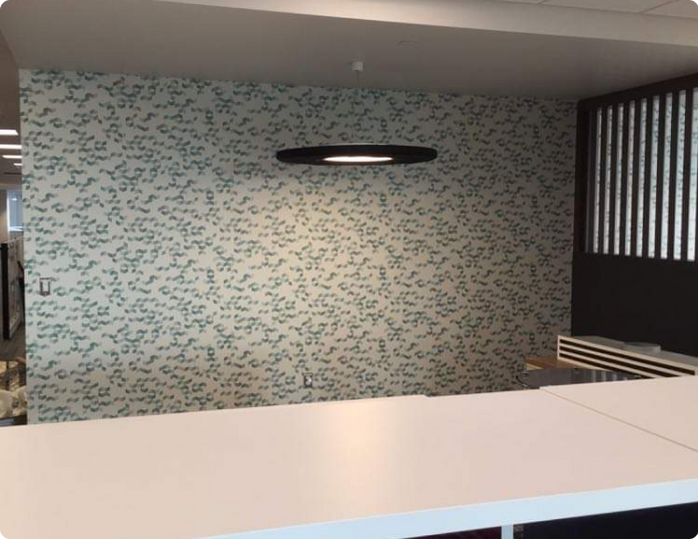 A white table in front of a wall with a pattern on it
