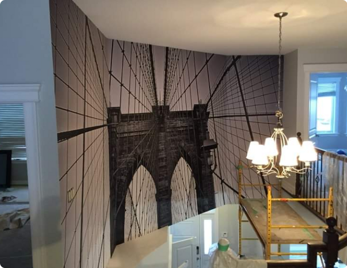 A wall with a picture of a bridge on it
