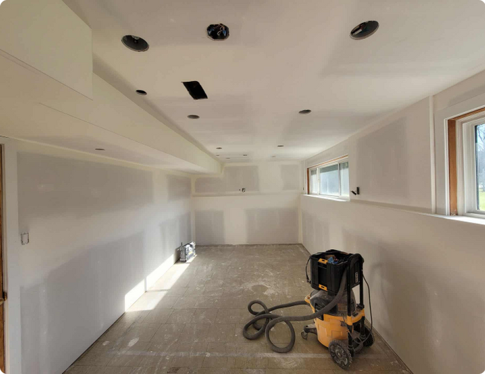 An empty room with a vacuum cleaner on the floor