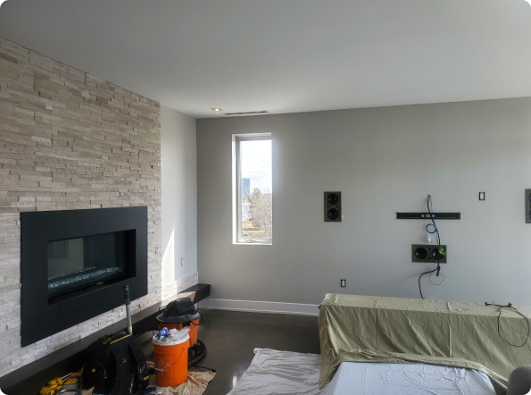 A living room with a fireplace and a large window