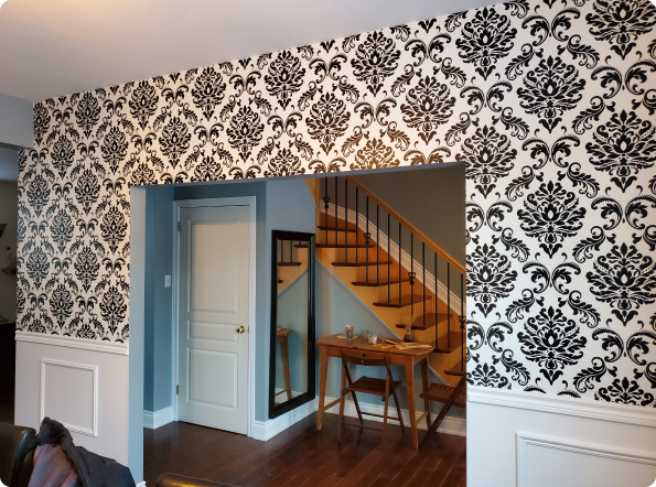 A room with a staircase and a table and chairs