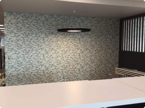 A room with a table and a wall with a pattern on it.