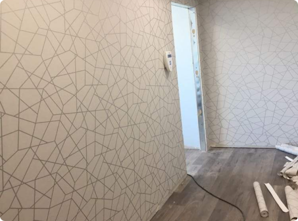 A hallway with a geometric pattern on the wall