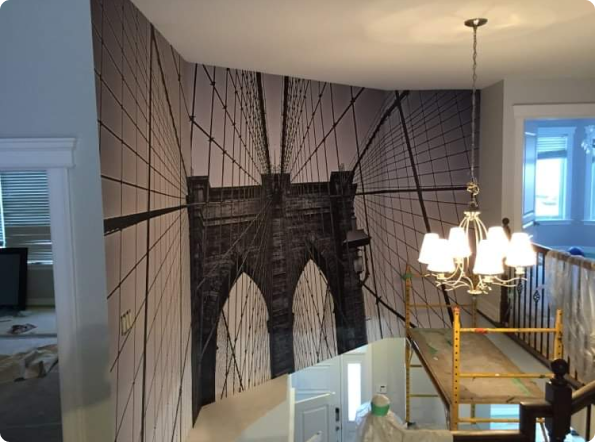 A staircase with a picture of a bridge on the wall