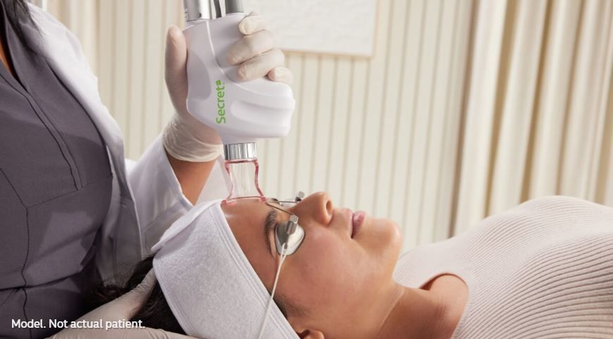 A woman is getting a laser treatment on her face. A woman is getting a laser treatment on her face.