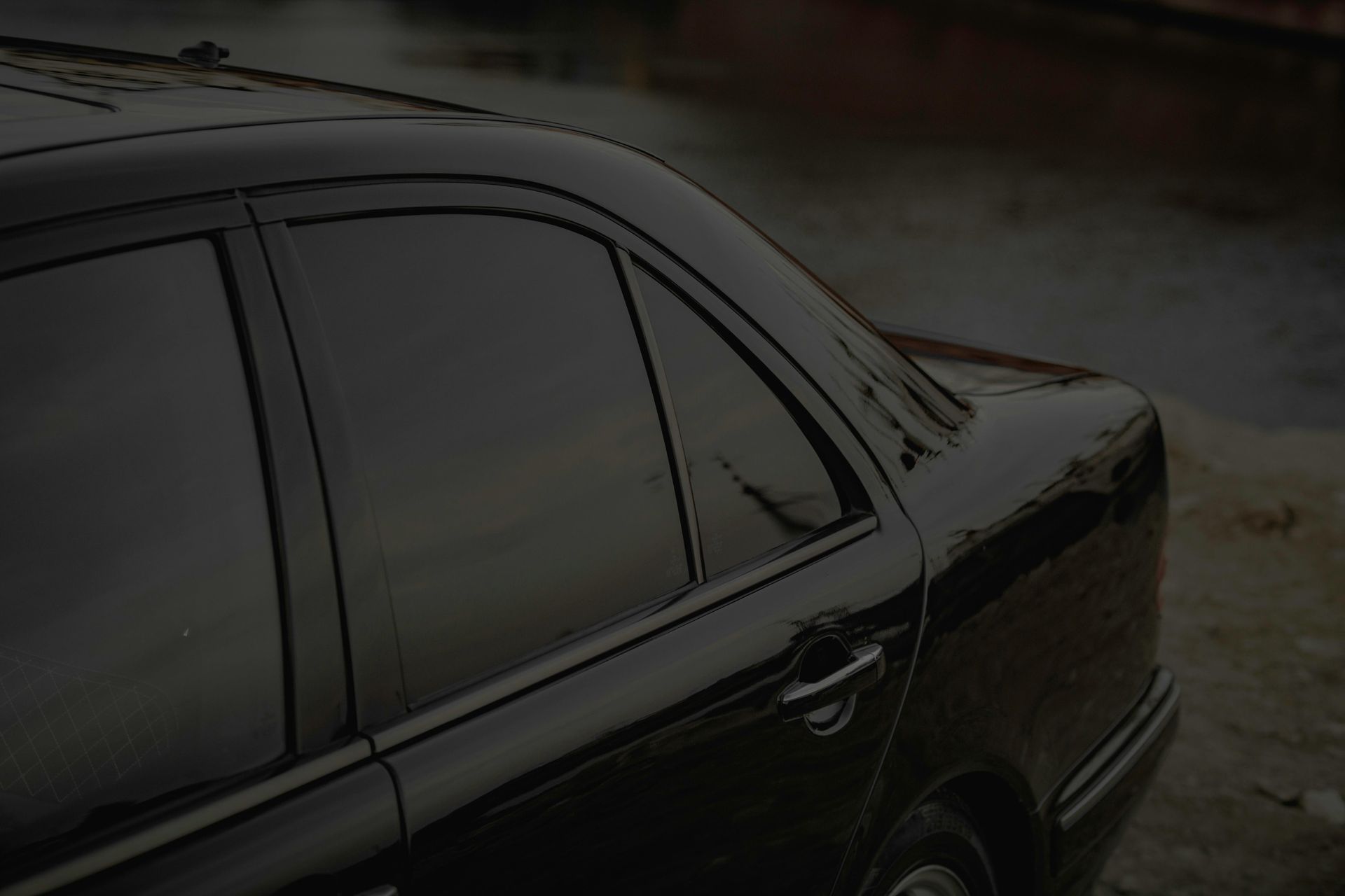Professional window tint installation on a car at Inspire Auto Studio in Richmond BC using LLumar