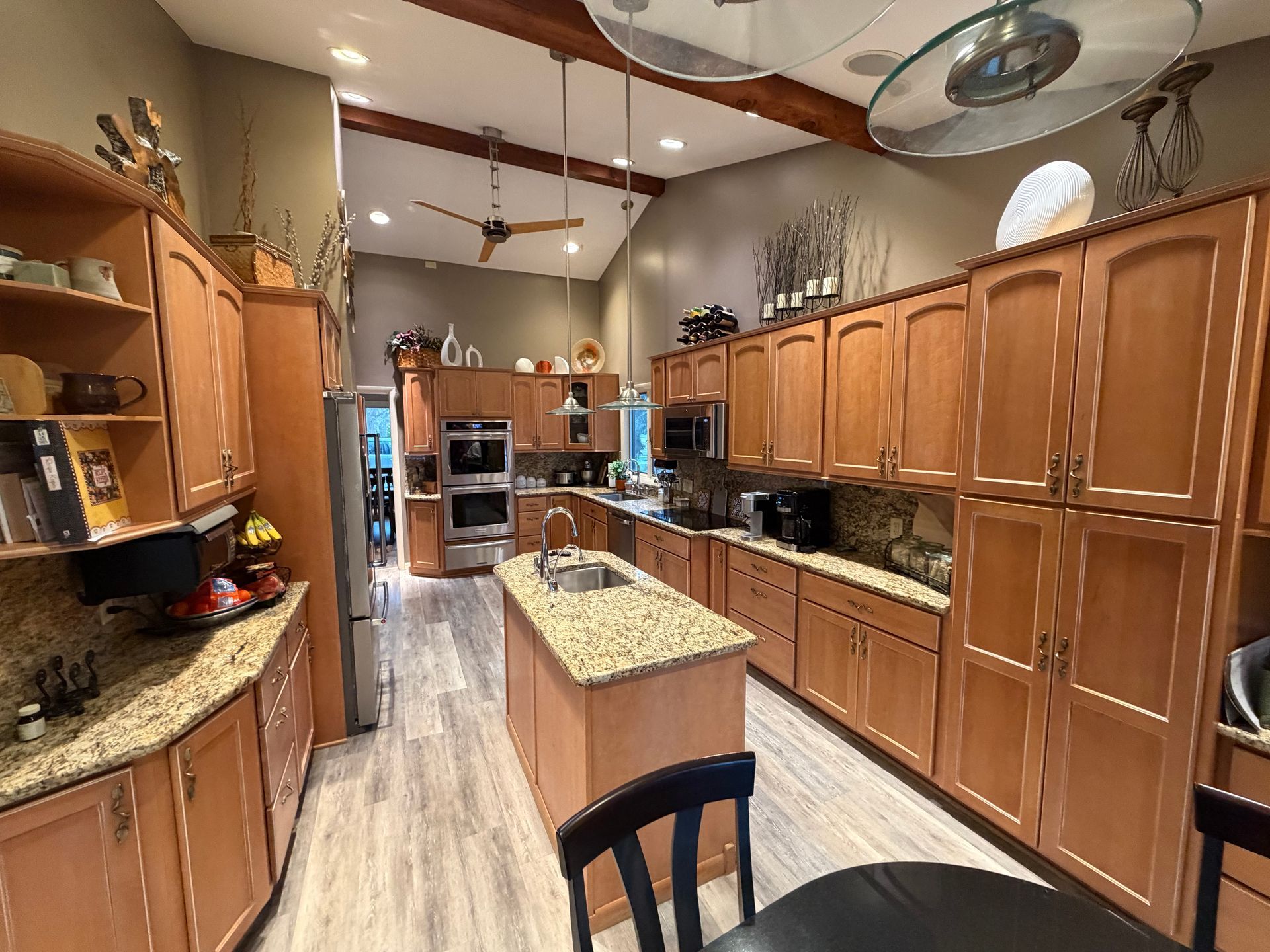 Kitchen under renovation with covered countertops, taped cabinets, and protective floor covering