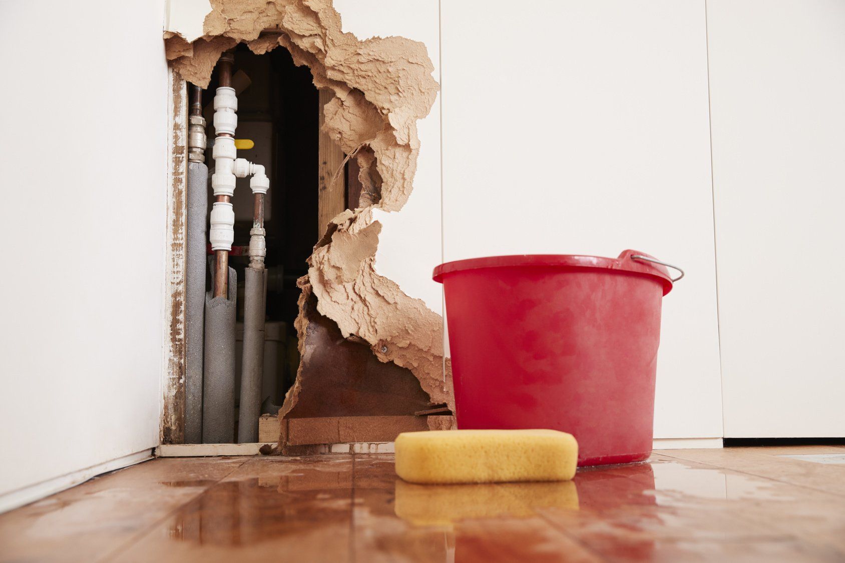 water pipes leaking behind wall