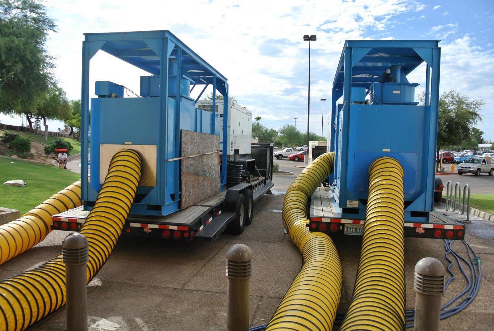 Two blue trucks with yellow hoses attached to them Fountain Valley 