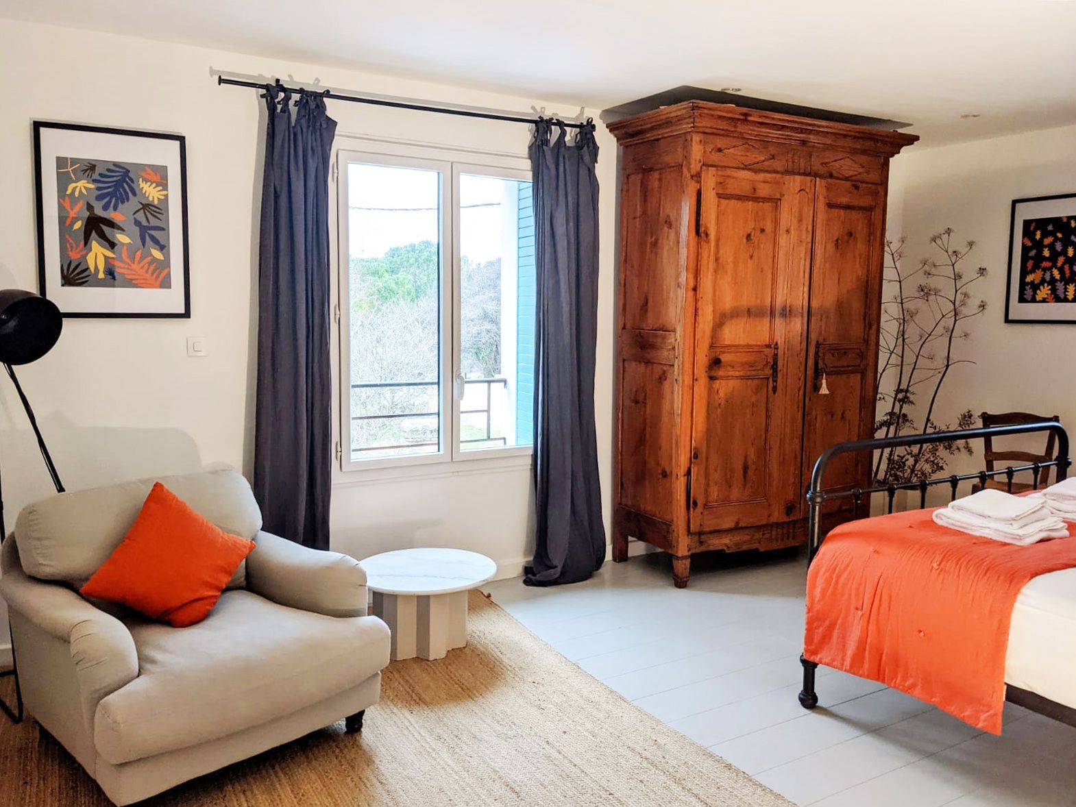 A bedroom with a bed , chair , table and wardrobe. A bedroom  at the Mas, Fleur de Lys Retreats.