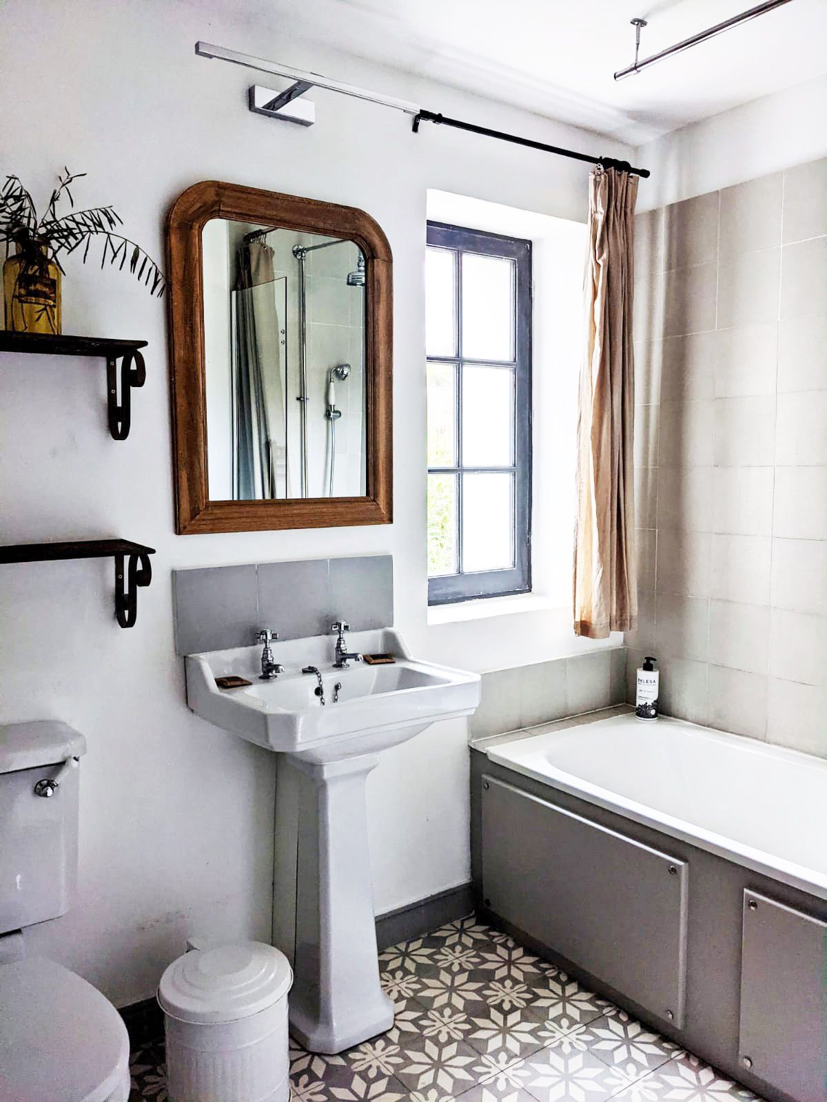 A bathroom with a sink , toilet , bathtub and mirror.  at the Mas, Fleur de Lys Retreats.