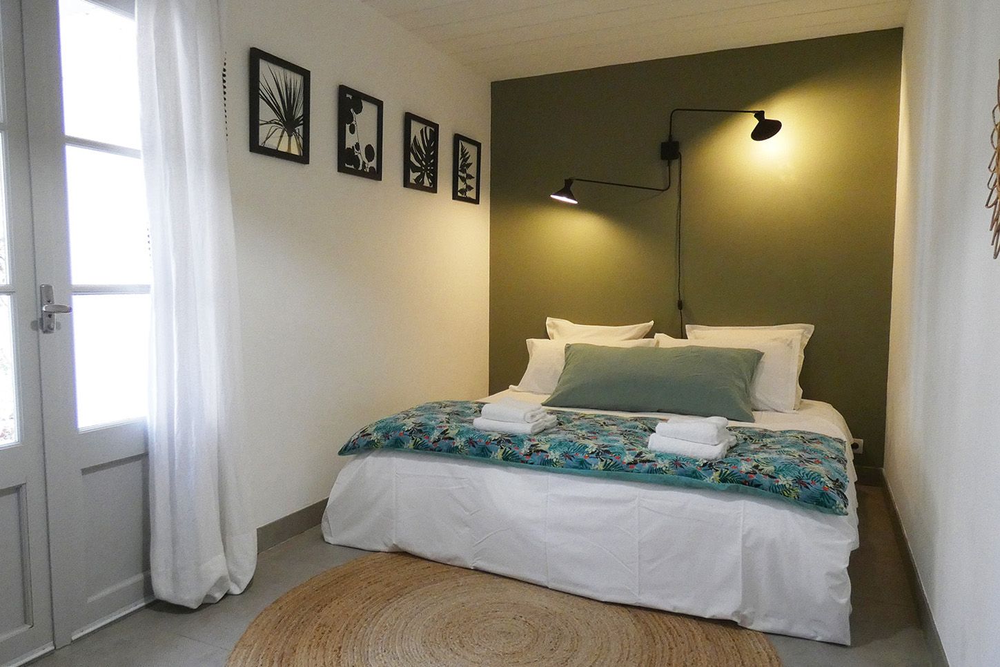 A bedroom with a bed and a rug on the floor at the Mas, Fleur de Lys Retreats.