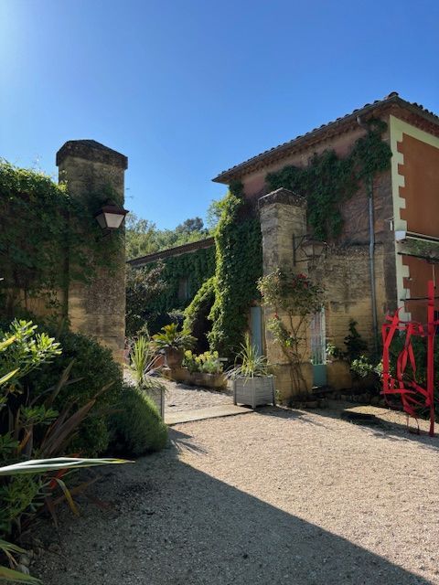 Sunlit courtyard with ivy-covered stone buildings at the retreat venue in southern France, used for The Art of Layers worksho