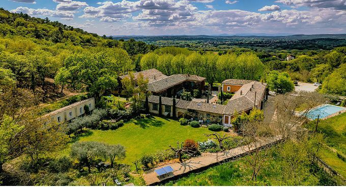 Aerial view of Mas des Oules, the retreat venue near Uzès, with stone houses and expansive countryside views