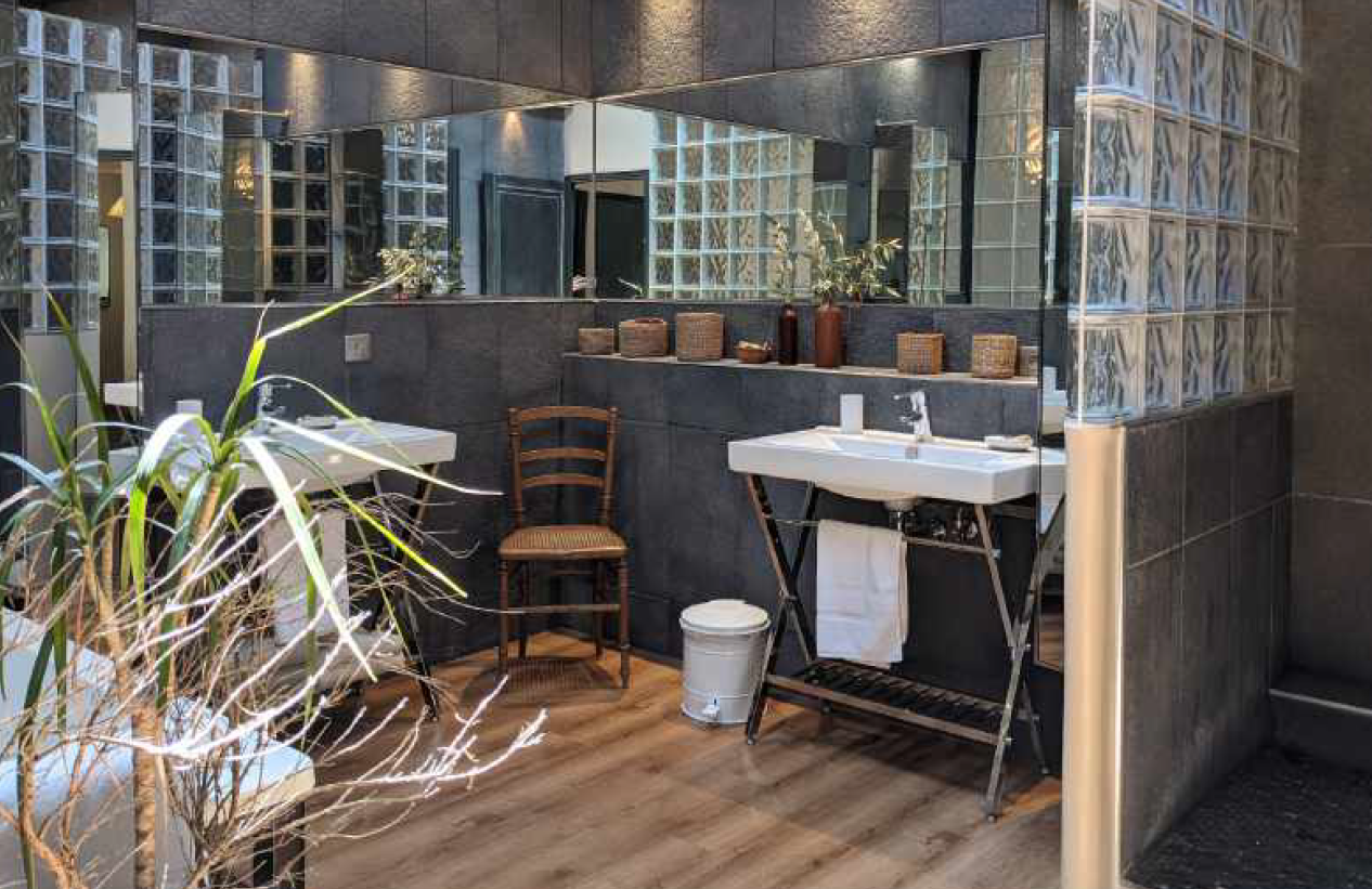 A bathroom with two sinks and a large mirror.