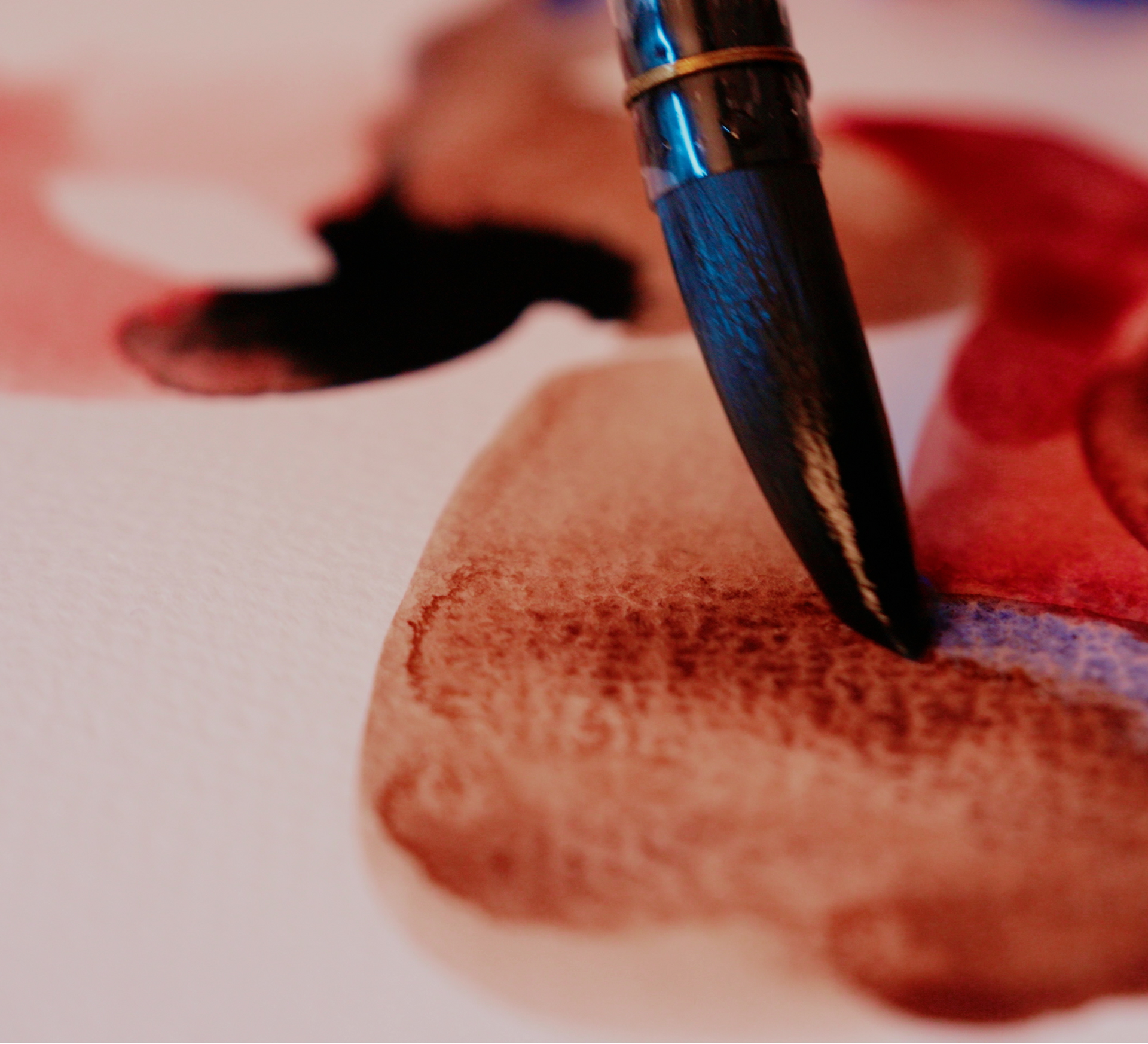 A close up of a brush on a piece of paper by artist Ana Falceta, the Creative Awakening Retreat with Fleur de Lys
