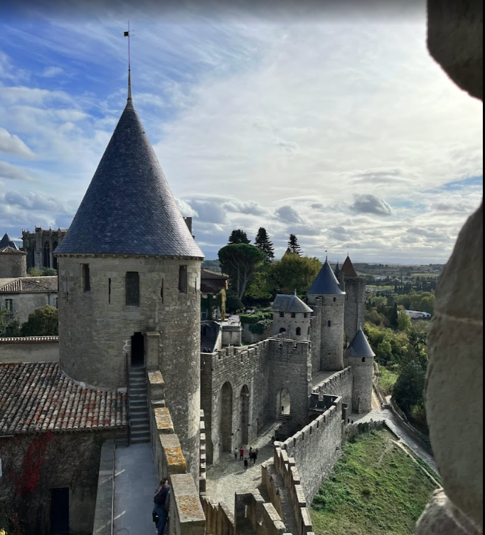 An aerial view of a castle with a cone shaped tower, Carcassonne, Fleur de Lys Retreats.