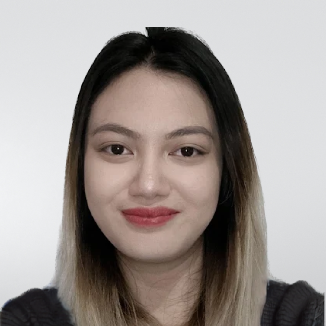 A portrait of a person with straight, dark-to-light ombre hair, smiling softly against a plain, light-gray background.