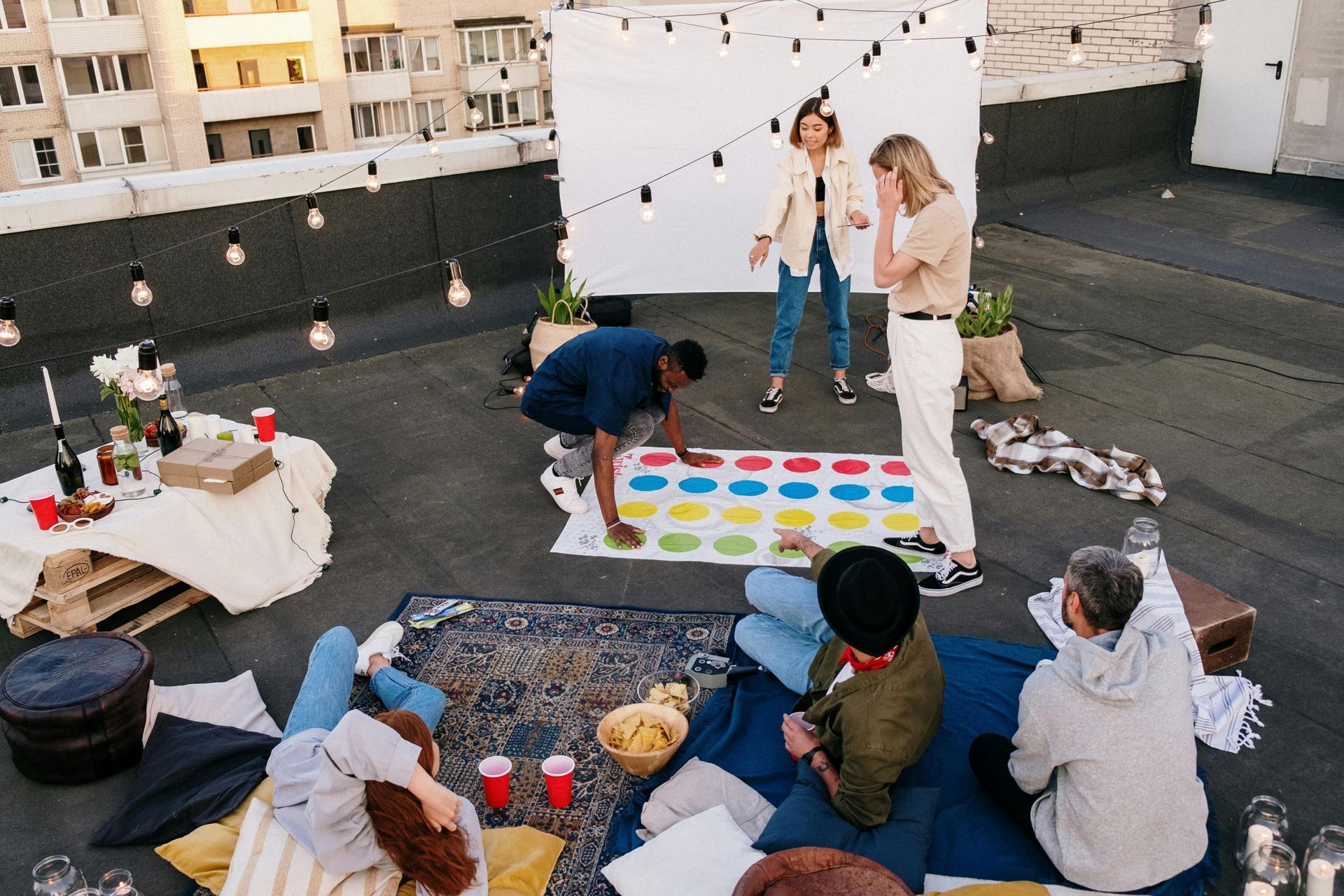 A group of people are playing a game on a rooftop.