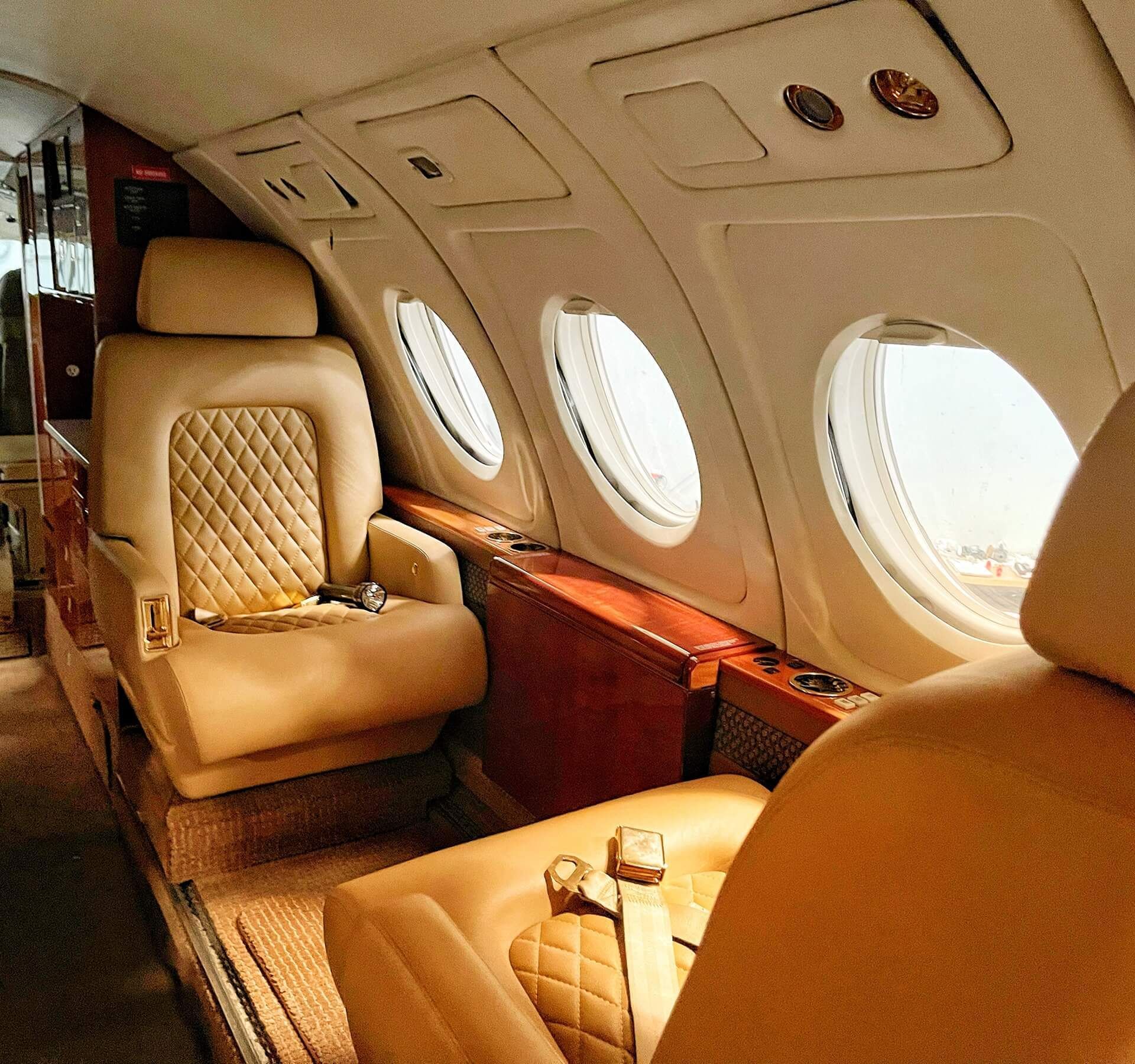 The inside of an airplane with a few seats and a window