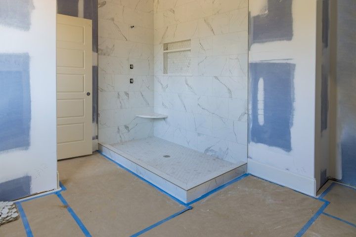 Under renovation: master bathroom with blue and white walls, ready for tiles