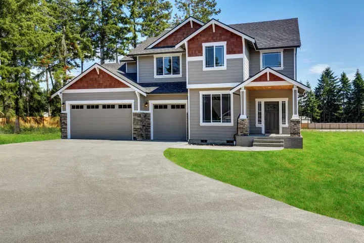 2 story home with green lawn and new driveway