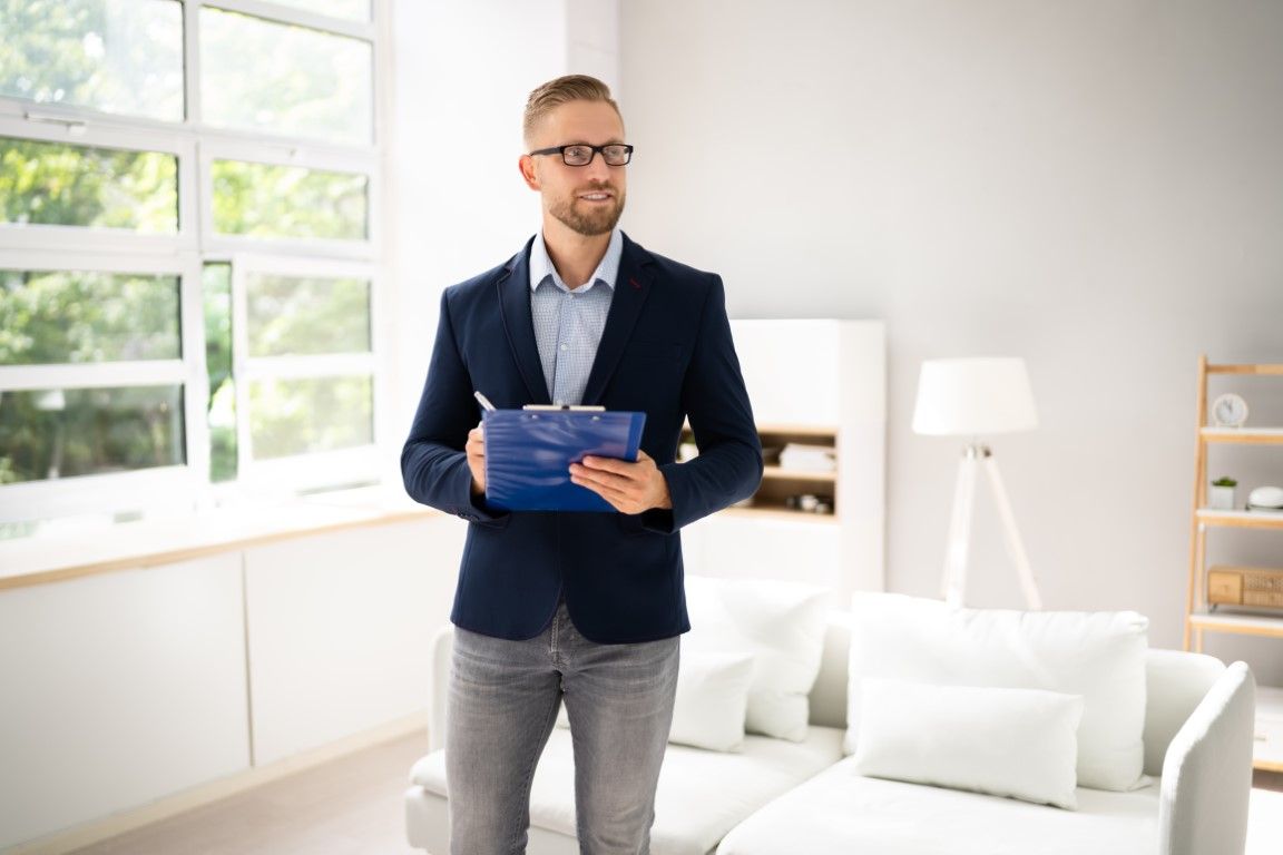 appraiser standing in living room making notes