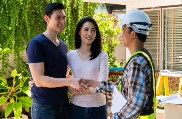 couple shaking hands with appraiser