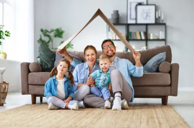 family goofing off under pretend roof in their home