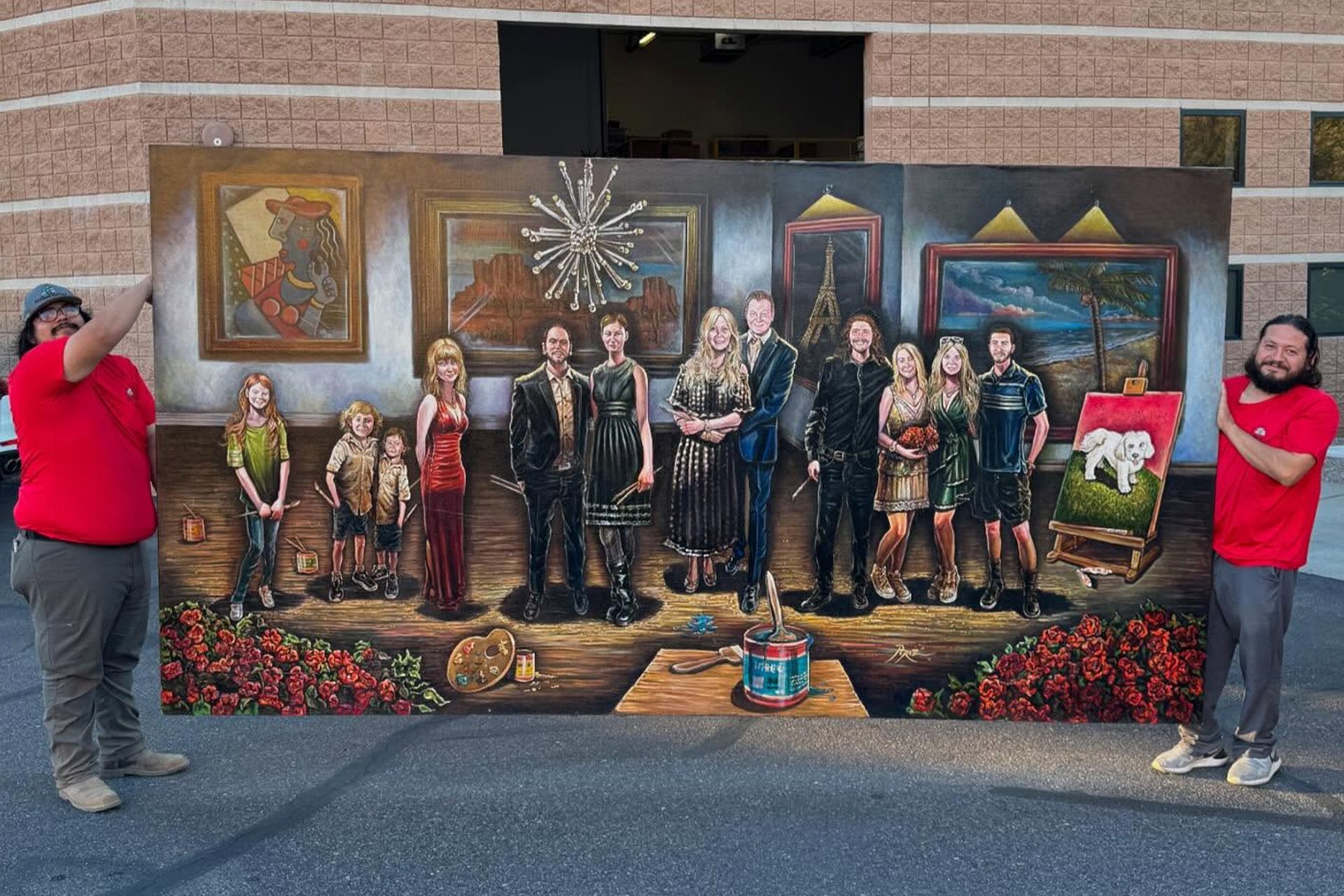 Mural of a family scene with two people in red shirts standing on either side, outdoors by a brick wall