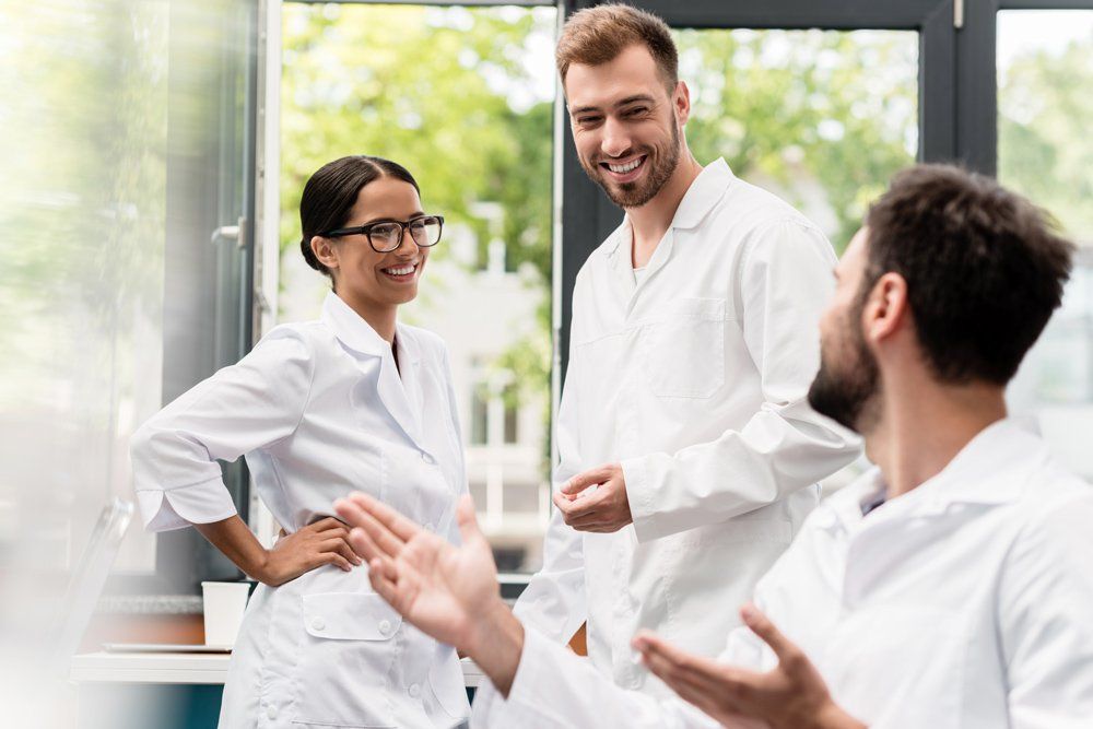 Team of professional scientists talking in laboratory
