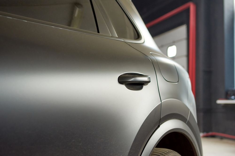 A close up of a car door in a garage.
