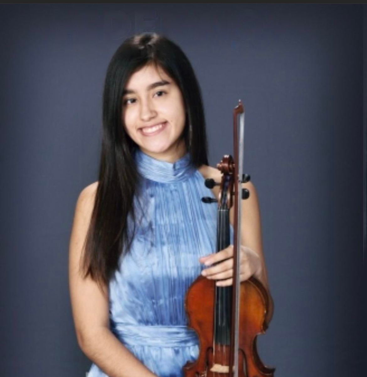 A woman in a blue dress is holding a violin