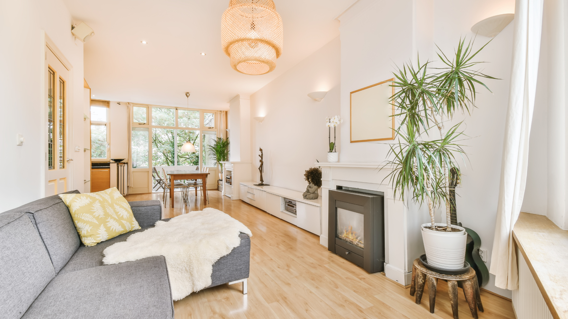 A living room with a couch , fireplace , and plant.