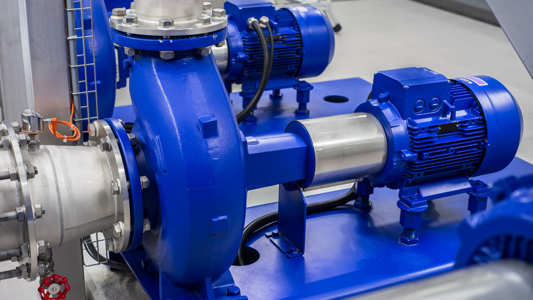 A close up of a blue water pump in a factory.