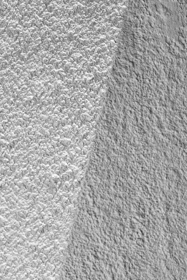 Close-up of two textured gray fabric surfaces meeting at a seam
