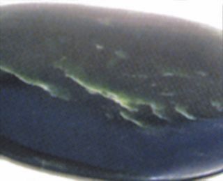 A close up of a black object on a white surface